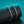 Two diamond bracelets on a black stand with a teal background