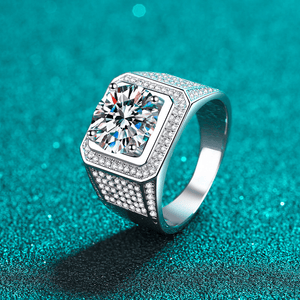 Silver ring with a large diamond on a teal background