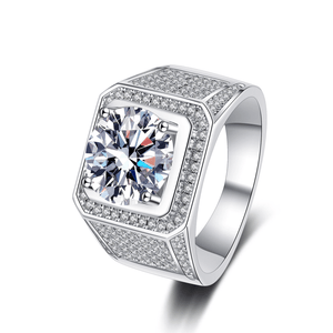 Silver ring with a large diamond and smaller diamonds on the band against a white background