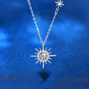 Silver necklace with a star-shaped pendant on a blue background
