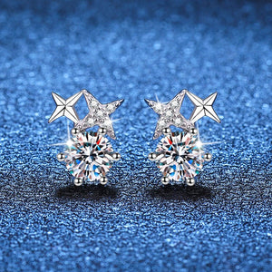 Star-shaped earrings with clear gemstones on a blue textured background