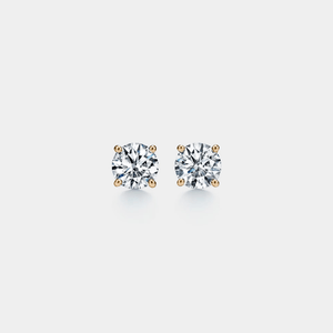 Pair of diamond stud earrings on a light gray background
