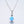 Two round opal charm necklaces with gold plating on a white background, one with a blue opal and the other with a white opal, both on silver chains.