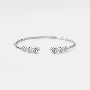 Silver bracelet with small diamonds on a light gray background