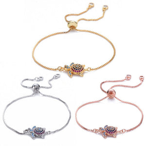 Three turtle-themed bracelets in gold, silver, and rose gold on a white background