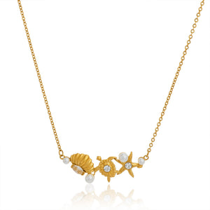 Gold necklace with seashell, starfish, and pearl pendant on a white background