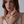 Model wearing a gold ring with sea turtle and starfish design on a white background