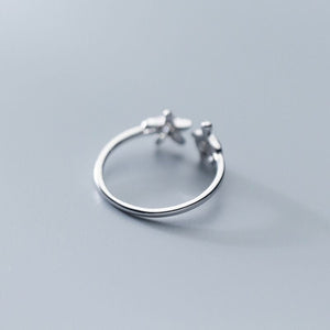 Silver turtle-shaped rings on a gray background.