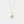 Gold necklace with a shell and pearl pendant on a light gray background