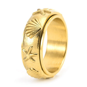 Gold ring with starfish and shell designs on a white background