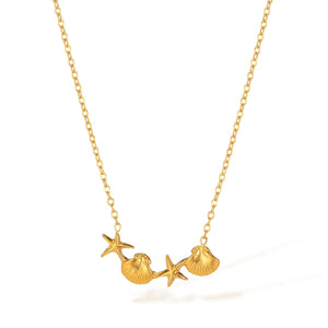 Gold necklace with starfish and shell charms on a white background