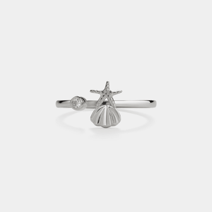 Silver ring with starfish and shell design on a white background