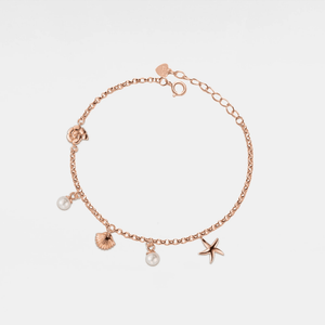 Rose gold bracelet with seashell, starfish and pearl charms on a light gray background