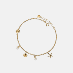 Gold bracelet with charms on a white background