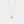 Gold necklace with a heart-shaped pendant on a light gray background