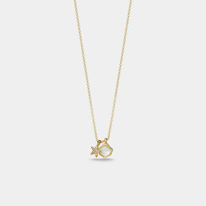 Gold necklace with a heart-shaped pendant on a light gray background