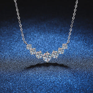 Silver necklace with diamond-like stones on a blue gradient background