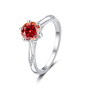 Silver ring with a red gemstone on a white background