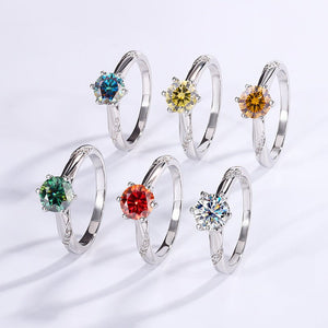 Set of silver rings with colorful gemstones on a white background