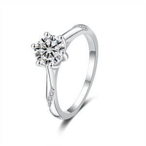 Silver ring with a diamond on a white background