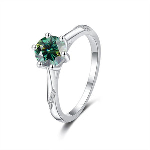 Silver ring with a green gemstone on a white background
