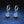 Pair of diamond hoop earrings on a dark blue textured background