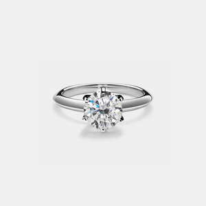 Silver ring with a large diamond on a light gray background