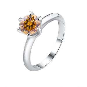 A solitaire color moissanite engagement ring with a hypoallergenic finish, set in a sterling silver band.