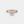 Rose gold ring with a diamond on a white background