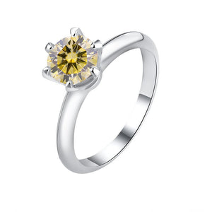 A solitaire color moissanite engagement ring with a hypoallergenic finish, set in a sterling silver band.