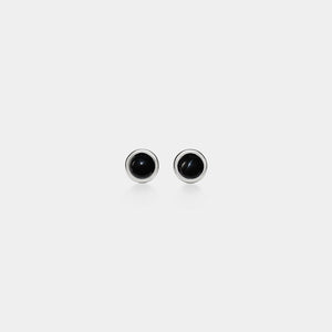 Pair of black stud earrings on a white background
