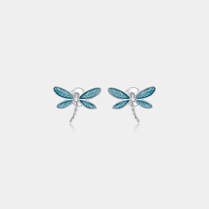 Dragonfly-shaped earrings on a light gray background