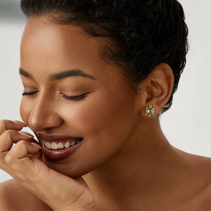 Woman wearing a blue gemstone sea turtle earring with a neutral background