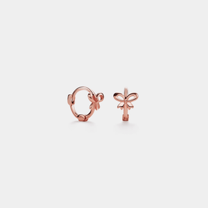 A pair of gold-colored bow knot hoop earrings made of sterling silver, displayed against a white background.