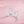Silver hoop earrings with floral designs on a pink background
