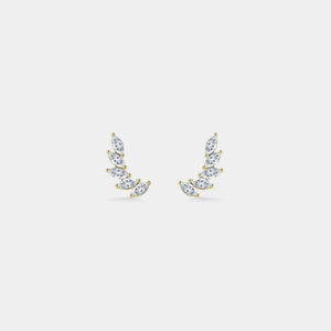 Pair of gold earrings with clear gemstones on a light gray background
