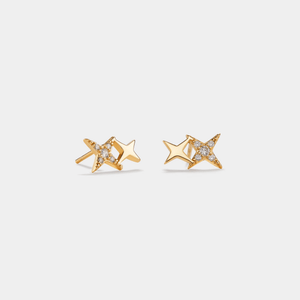 Gold star-shaped earrings with small diamonds on a light gray background