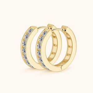 Gold hoop earrings with embedded stones on a white background