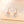 A set of three celestial-themed drop stud earrings, featuring designs resembling moons and stars, in silver and gold colors, embedded with clear stones.