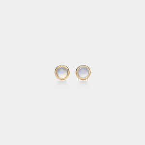 Pair of gold earrings with moonstone stones on a light gray background