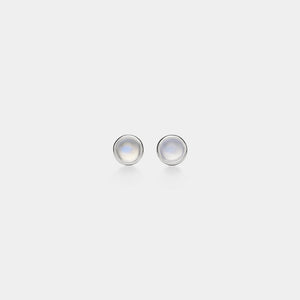 Pair of silver earrings with rainbow moonstone stones on a light gray background