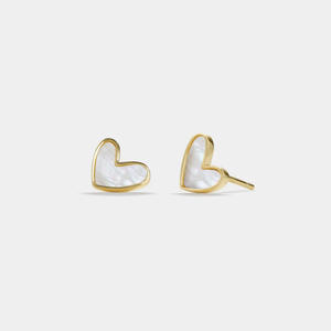 Heart-shaped earrings with gold frame and white center on a light gray background