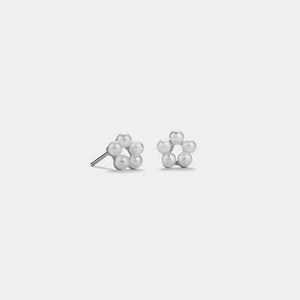 Pair of pearl earrings on a light gray background