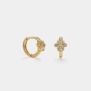Gold hoop earring with paw design on a light gray background