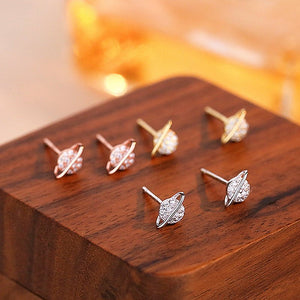 Set of earrings on a wooden surface with a warm background