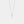 Silver necklace with a round pendant on a light gray background