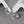 Silver hoop earrings on a gray surface with a white background