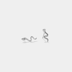 A pair of gold-colored stud earrings designed in the shape of a snake.