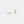 Gold snake-shaped earrings on a light gray background
