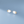 Pair of cloud-shaped earrings with gold stars on a light blue background
